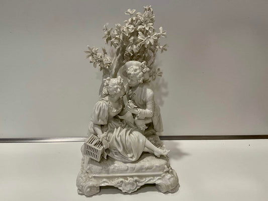 White Porcelain Sculpture of Man Courting Woman in Garden