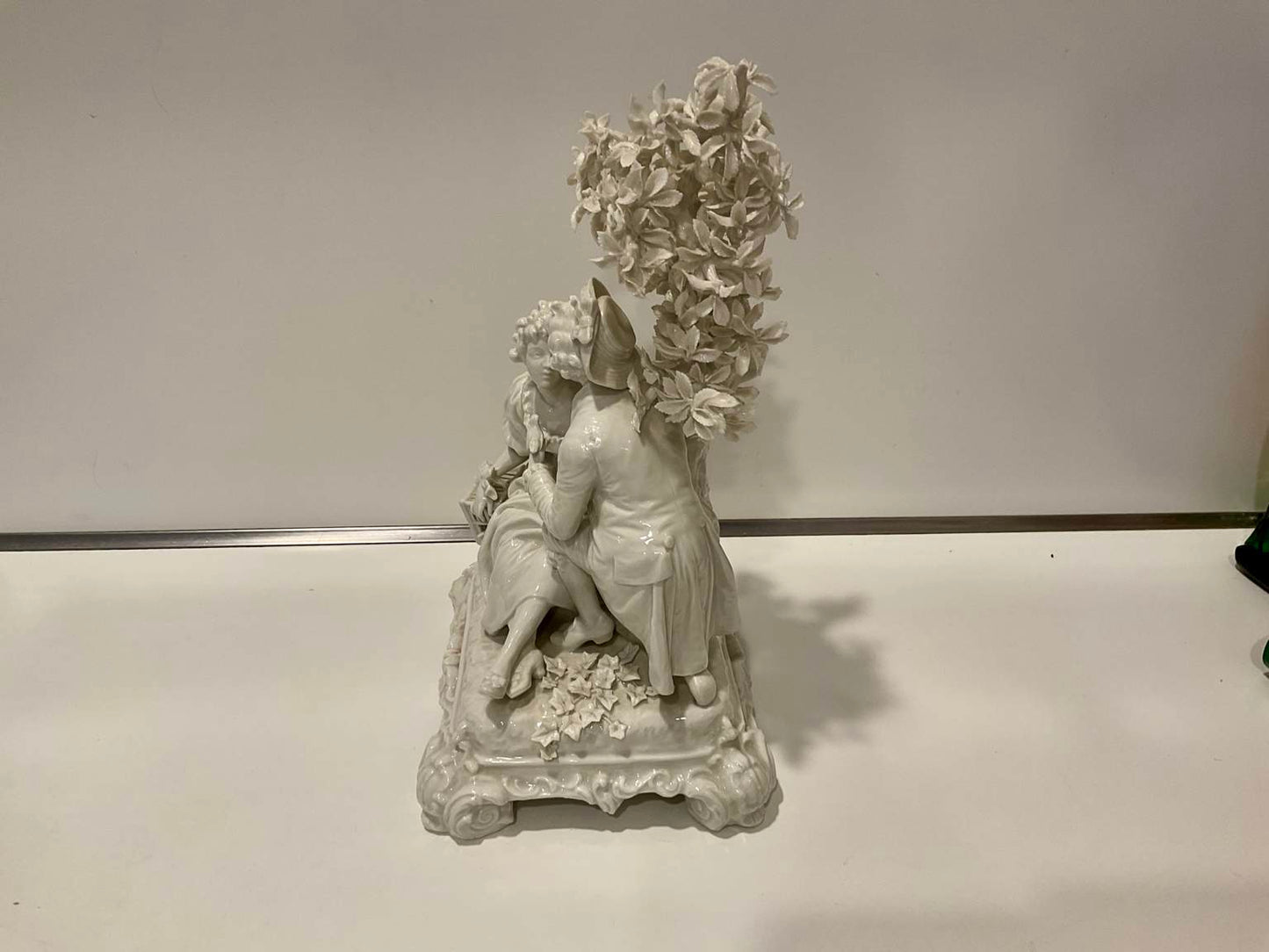 White Porcelain Sculpture of Man Courting Woman in Garden