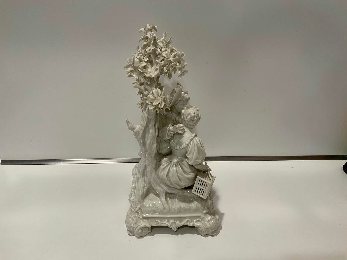 White Porcelain Sculpture of Man Courting Woman in Garden
