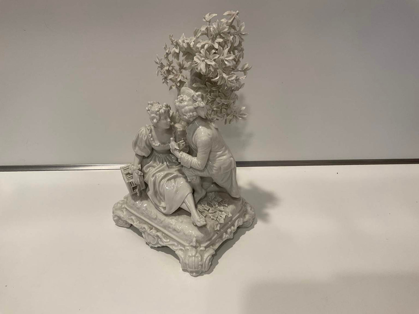 White Porcelain Sculpture of Man Courting Woman in Garden