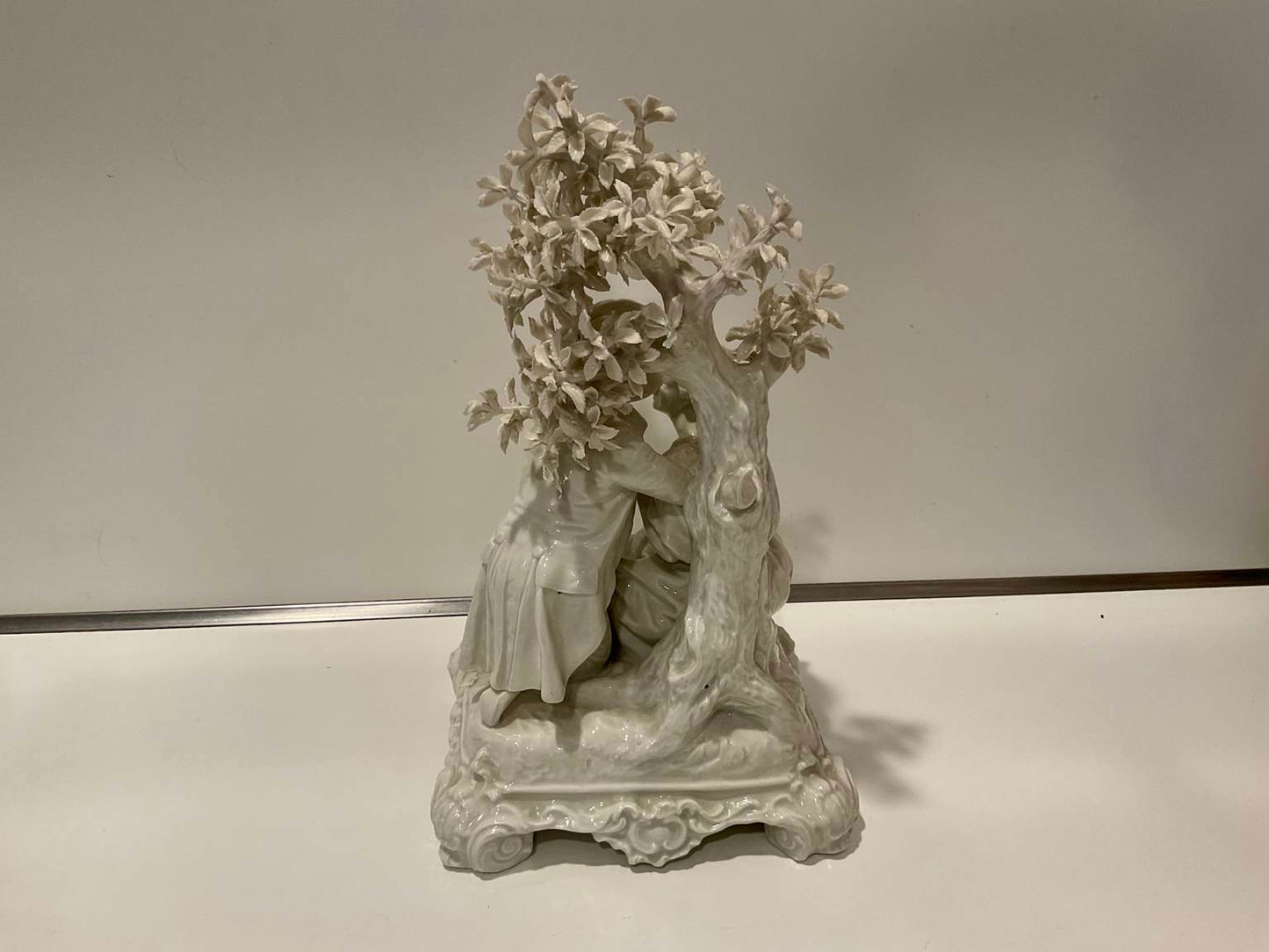 White Porcelain Sculpture of Man Courting Woman in Garden