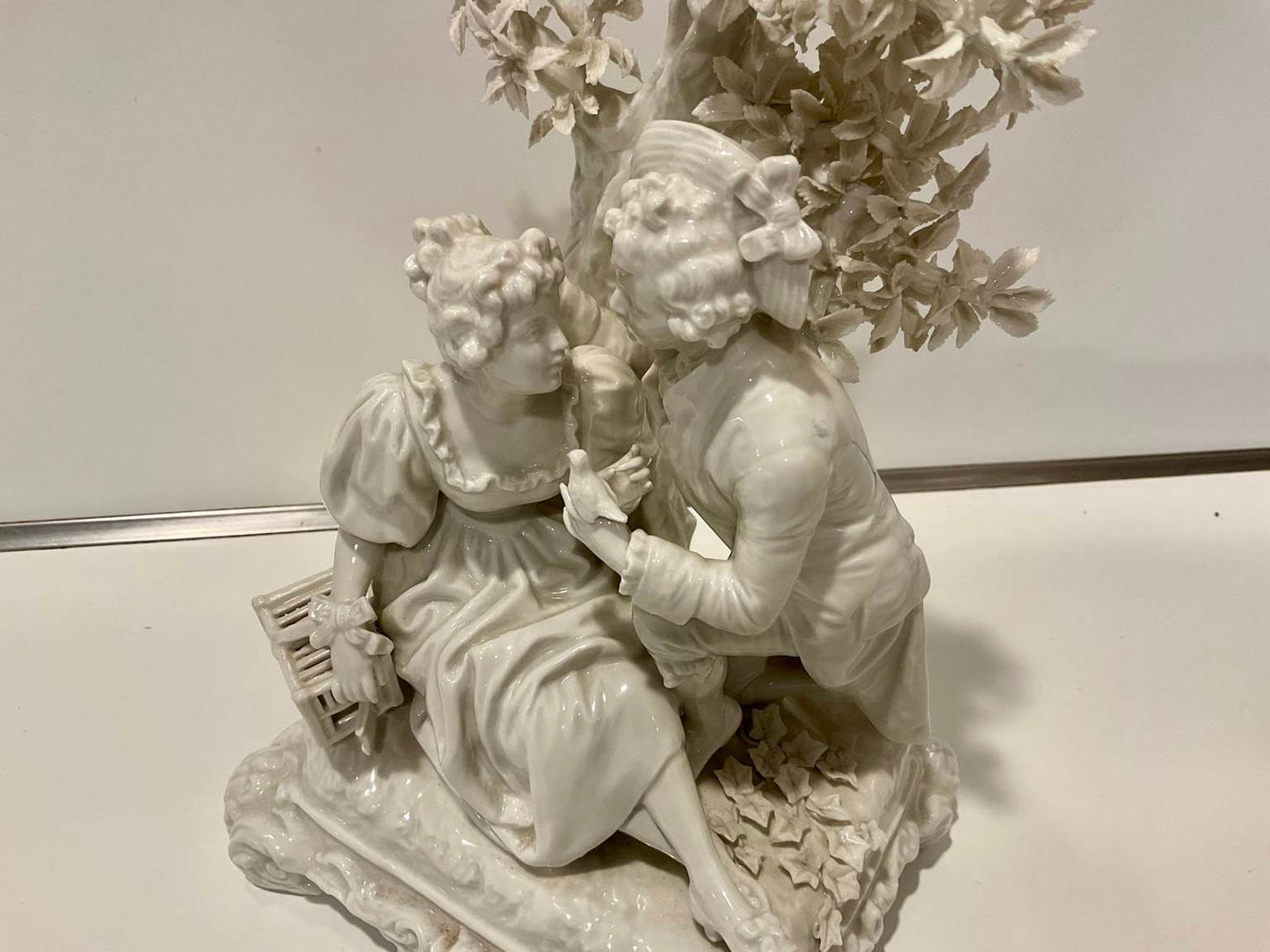 White Porcelain Sculpture of Man Courting Woman in Garden