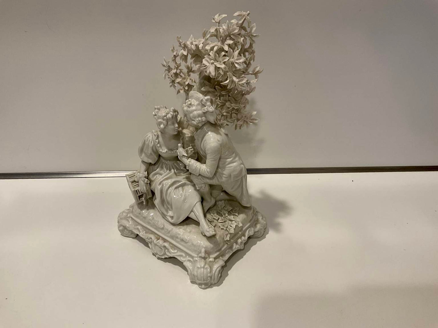 White Porcelain Sculpture of Man Courting Woman in Garden