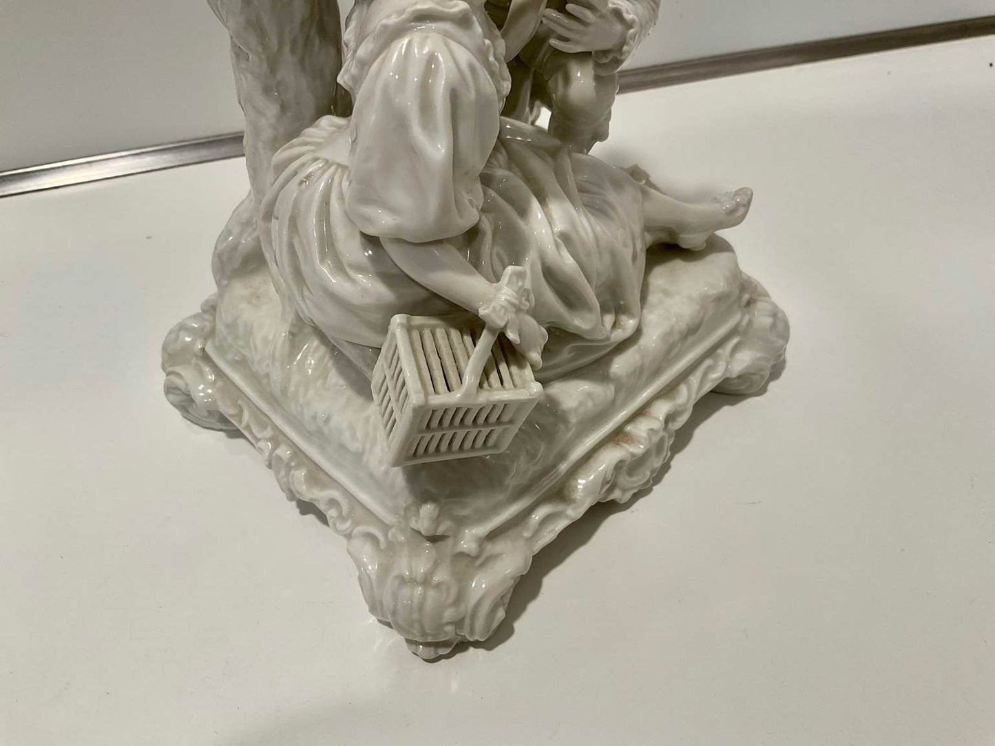 White Porcelain Sculpture of Man Courting Woman in Garden